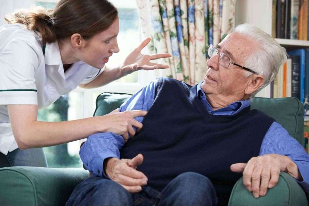 Care worker yelling at elderly man